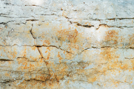 Closeup of a cracked brown composite material wall resembling a bedrock pattern with beige and wood undertones, creating a unique rectangle brick designの写真素材