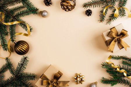 Christmas background with fir branches, golden ribbons, ornaments and wrapped gifts in festive flat lay design. Top view, copy spaceの写真素材