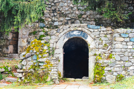 Arched stone entrance covered with moss and surrounded by natural greenery and rustic walls. Kastel Fortress in Banja Luka, Bosnia and Herzegovina.の写真素材