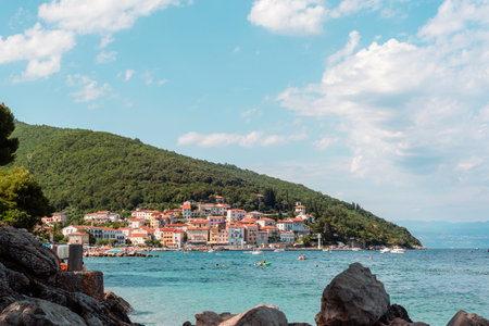 Seaside village with colorful buildings at the base of a green hill. Moscenicka Draga in Istria region, Croatiaの写真素材