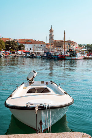 A boat moored at the pier in Krk, Croatiaの写真素材
