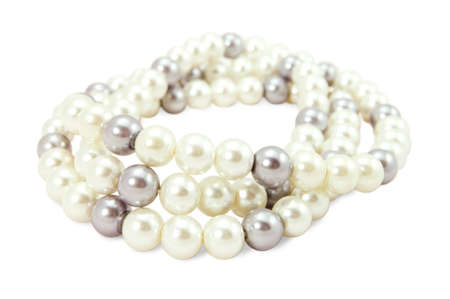 beads of white and black pearls on a white backgroundの写真素材
