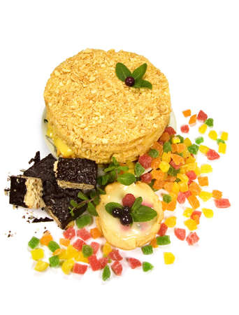 cake, waffles and candied fruit on a white background