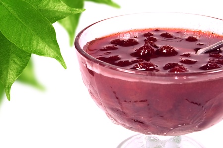 strawberry jam in a glass vase on a white backgroundの写真素材