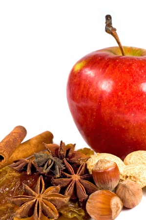 apple, raisins, nuts and cinnamon on a white backgroundの写真素材