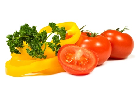 tomatoes, peppers and parsley on a white backgroundの写真素材
