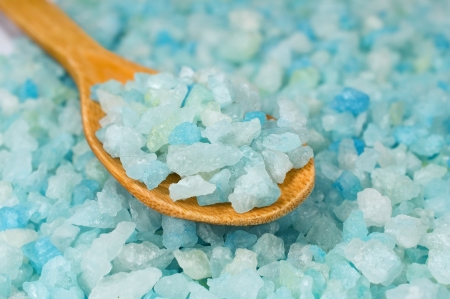 blue background with a texture of sea salt and spoonの写真素材