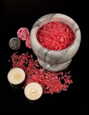 stone mortar , sea salt and candles on a black backgroundの写真素材