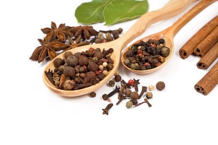 spices in wooden spoons on a white backgroundの写真素材