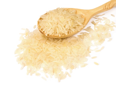 rice in a wooden spoon on a white backgroundの写真素材