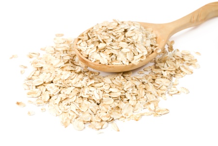 oatmeal in a wooden spoon on a white backgroundの写真素材
