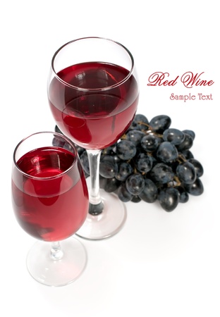 two glasses of red wine and grapesの写真素材