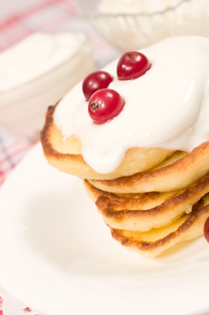 sweet pancakes with cranberries and sour cream closeup
の写真素材