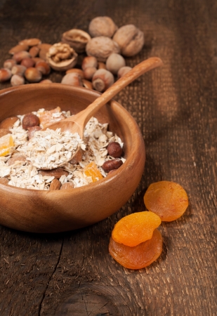 oatmeal with nuts and dried apricots in a wooden bowl
の写真素材