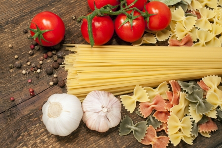 background with spaghetti, farfalle , cherry tomatoes and garlic
の写真素材