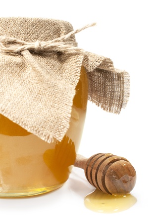 jar of honey with a wooden spoon on a white
の写真素材