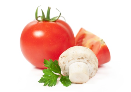 fresh tomato and mushroom isolated on whiteの写真素材