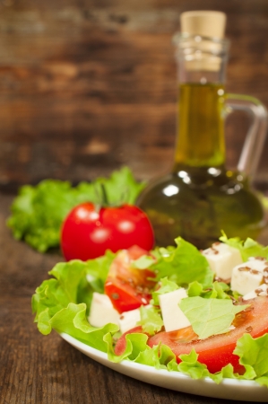 fresh vegetable salad with olive oil on a wooden background
の写真素材