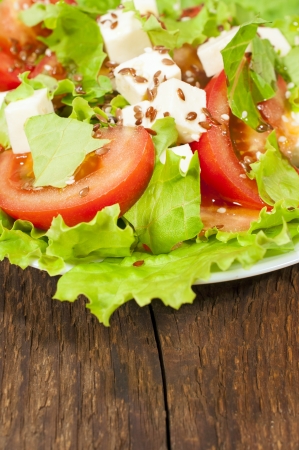 salad with fresh vegetables on wooden background close-up
の写真素材