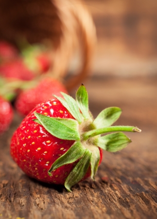 Ripe strawberry close-up on wooden backgroundの写真素材