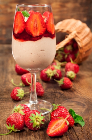strawberry dessert with mousse and fresh berries on the wooden backgroundの写真素材