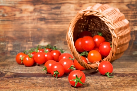 cherry tomatoes in a wicker basketの写真素材