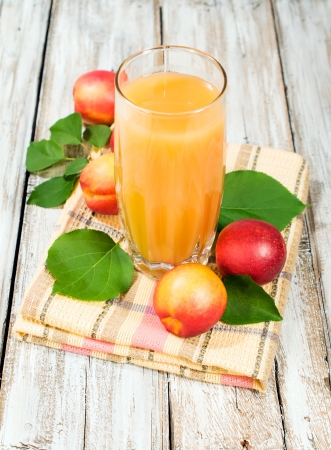 peach juice and fresh nectarines on a fabric napkinの写真素材