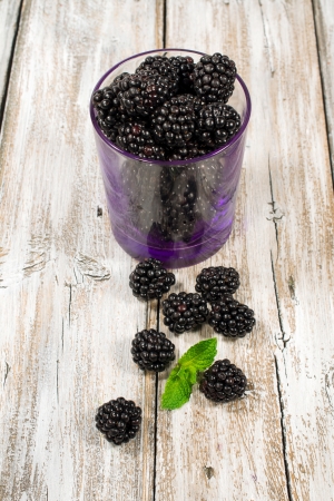 blackberry in a glass on a wooden backgroundの写真素材