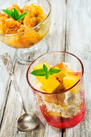 cottage cheese dessert with peaches on a wooden backgroundの写真素材