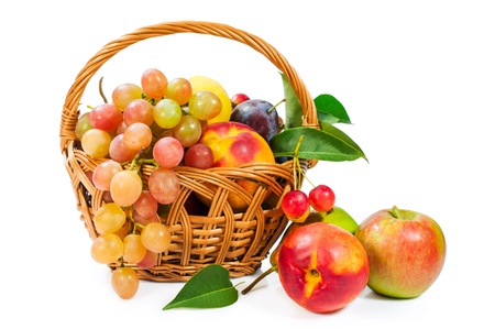 basket of fruit : apples , grapes , peaches and plumsの写真素材