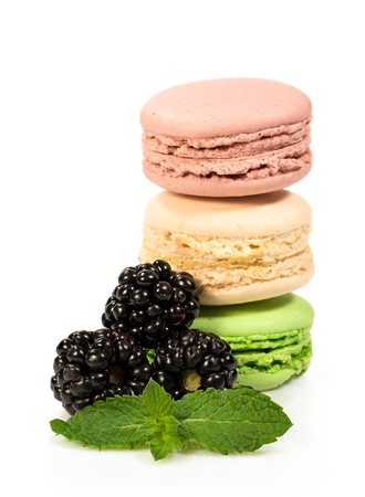 colorful macaroons with ripe blackberry and mint isolated on whiteの写真素材