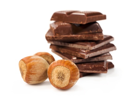 chocolate pieces with hazelnuts close-up isolated on whiteの写真素材