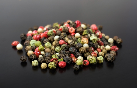 colorful peppers on a black background close-upの写真素材