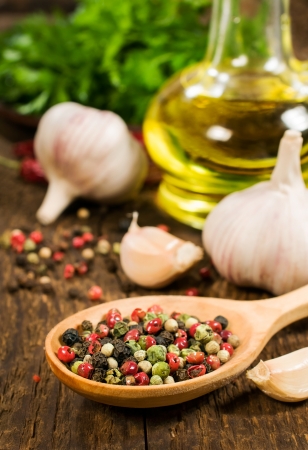 garlic, vegetable oil and spices on wooden backgroundの写真素材