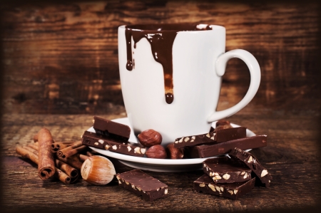  cup of hot chocolate with nuts and cinnamon on wooden backgroundの写真素材
