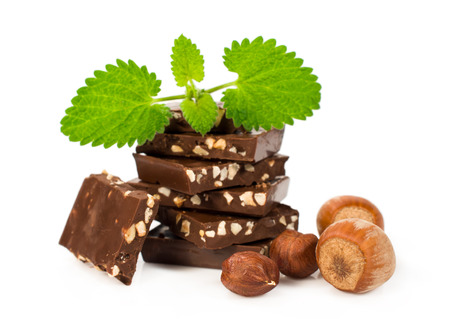 chocolate with hazelnuts and fresh mint leaves over whiteの写真素材