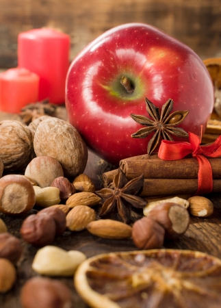 ingredients for Christmas baking : apple , nuts , cinnamon and dried orangeの写真素材