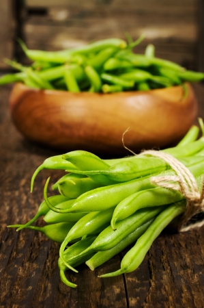 bunch of green beans on a wooden backgroundの写真素材