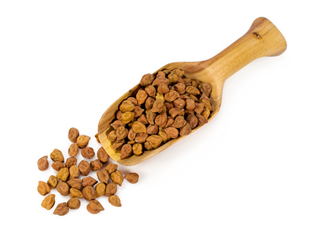 chick peas in a wooden scoop isolated on whiteの写真素材