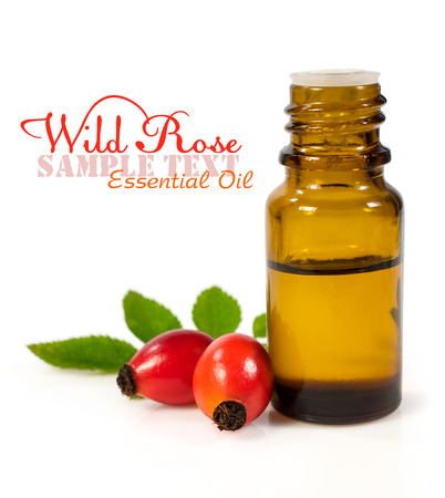 bottle of essential oil of rose hips isolated on whiteの写真素材
