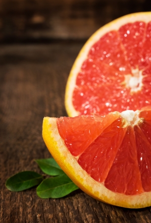 juicy ripe grapefruit on a wooden backgroundの写真素材