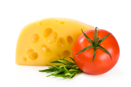 cheese with tomatoes and rosemary isolated on whiteの写真素材
