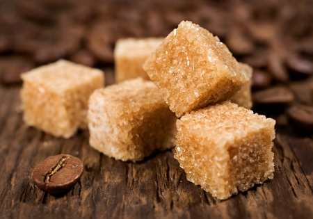 brown cane sugar with coffee beans on wooden backgroundの写真素材