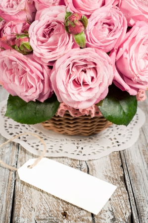 pink roses on a lace napkin with blank labelの写真素材