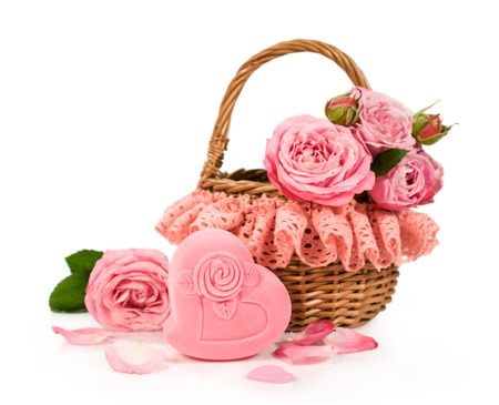 Basket with roses and gift box isolated on whiteの写真素材