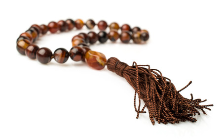 Rosary of carnelian beads isolated on whiteの写真素材