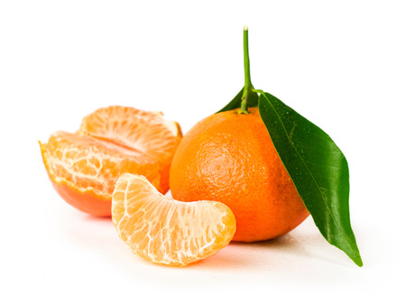 Ripe tangerine with clove  isolated on whiteの写真素材