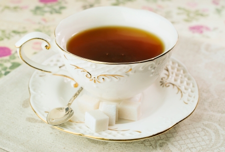 Gourmet tea cup with sugar cubes on a linen napkinの写真素材