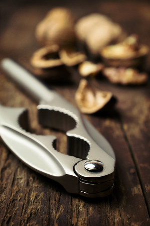 nutcracker and walnuts on a wooden backgroundの写真素材