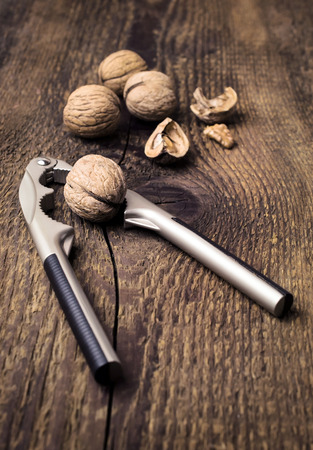 nutcracker and walnuts on a wooden backgroundの写真素材